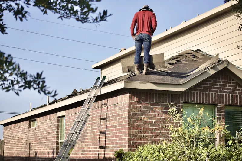 Professional roofer working on a residential roof in Marysville